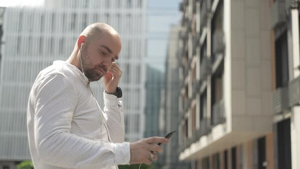 A Businessman Puts on Headphones Turns on Music and Dances