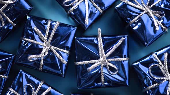 Blue Gift Boxes on Blue Color Background. Christmas and New Year Rotating Backdrop. Present