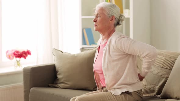 Senior Woman Suffering From Pain in Back at Home