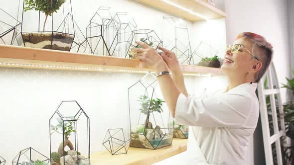 Senior Modern Florist Woman Look After Plants in Capsule