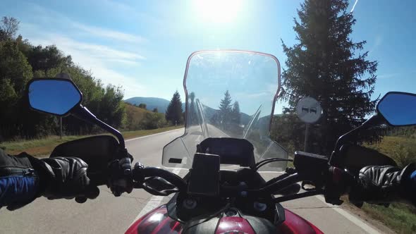 POV Biker Rides on Motorbike By Scenic Sunny Mountain Road on Plateau in Croatia