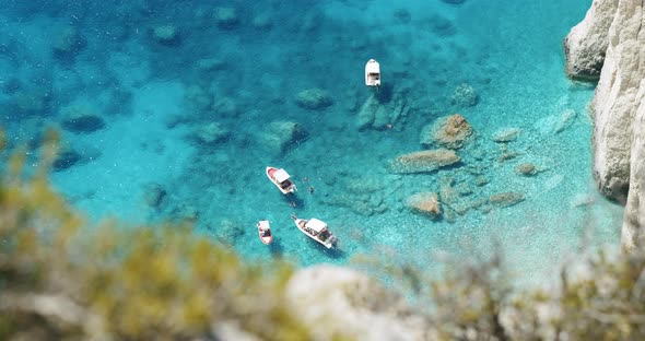 Pleasure Tourist Boats on Secluded Beach with Blue Water