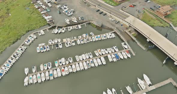 Many Boats and Yachts are Near Pier in Ocean Bay in Sunny Summer Day