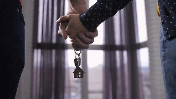  Couple Holding Hands with New Home Keys