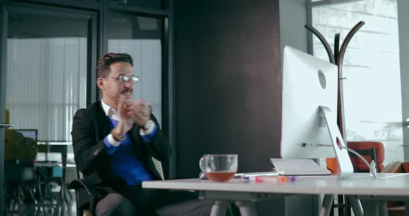 Businessman in the Office in Front of the Computer Showing Anger