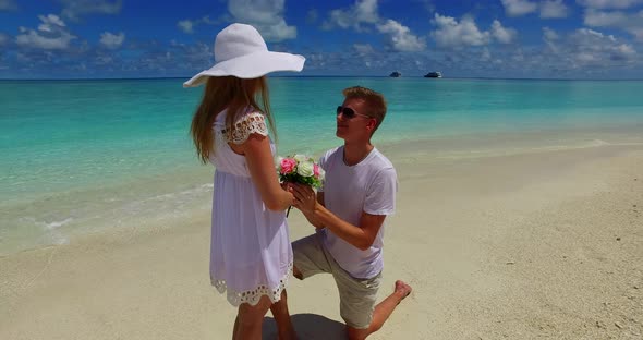 Young boy and girl after marriage in love spend quality time on beach on sunny white sandy backgroun