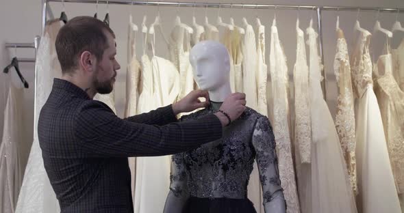 Fashion Designer Trying on a Sewn Evening Dress on a Mannequin in Atelier
