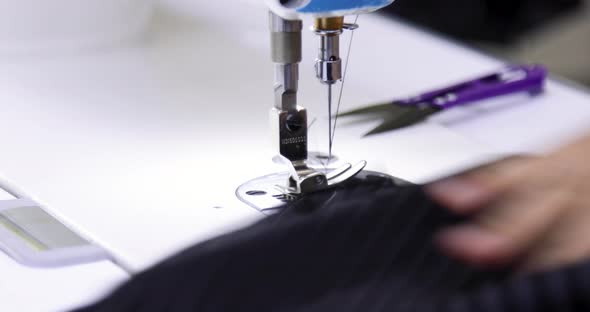 Tailor working on electric sewing machine