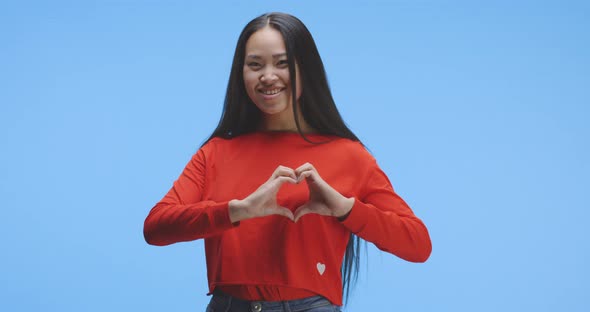 Young Woman Forming Heart with Her Hands