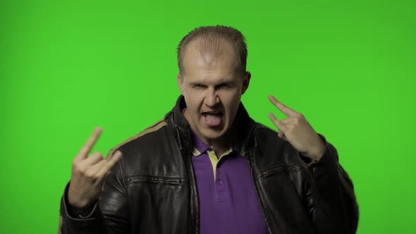 Rocker Man Showing Rock and Roll Sign, Devil Horns Gesture, Looking with Crazy Expression