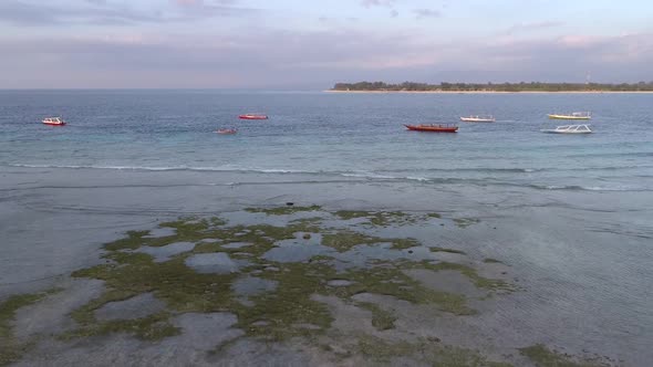 Aerial view at group of traditional boats anchored near coast, Indonesia.