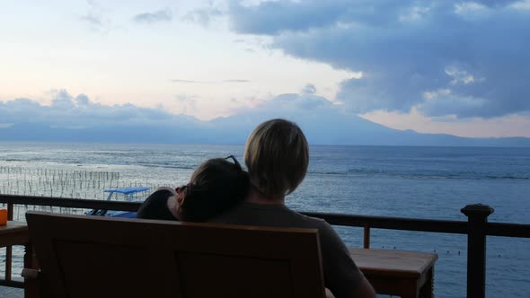 Young Couple Looking on Volcano and Ocean