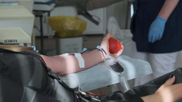 Blood Donor at Donation at Medical Centre. Close Up Footage Arm of Woman Receiving Blood in Hospital