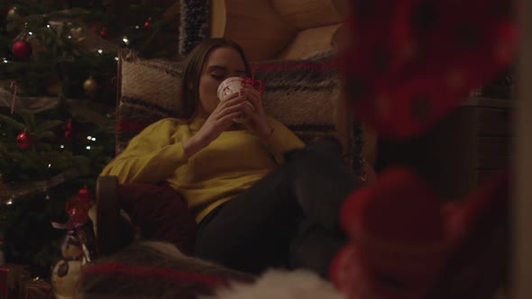 Woman relaxing in an armchair