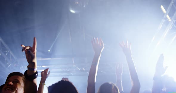 Group of people dancing at a concert 4k