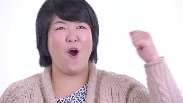 Face of Happy Overweight Asian Woman Getting Good News Ready for Winter