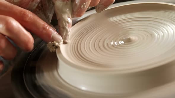 Male potter making pot