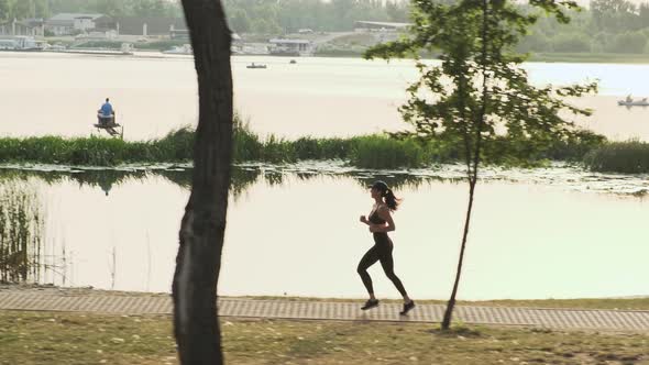 Side View Young Fitness Woman Jogging Outdoor