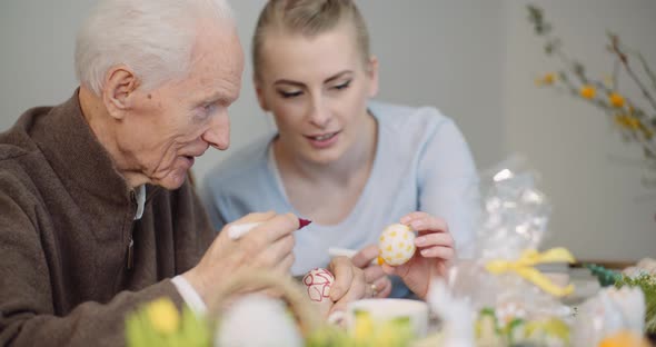 Senior Man and Woman Painting Easter Eggs