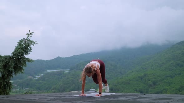 Cardio Training in the Mountains Woman Doing Burpees