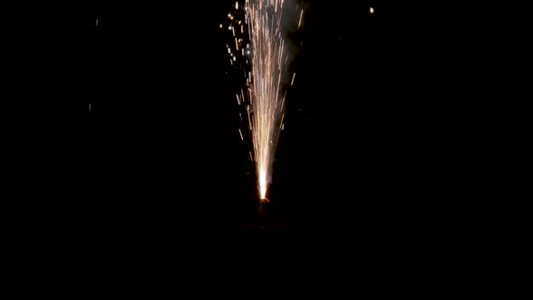 Sparks flying from sparkler firework in darkness