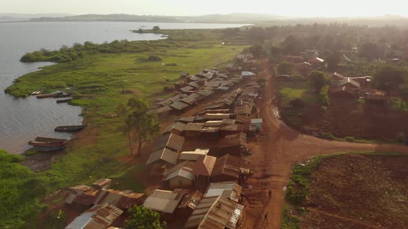 Aerial shot of a fishing village slum on the edge of lake Victoria Africa in the golden glow of suns