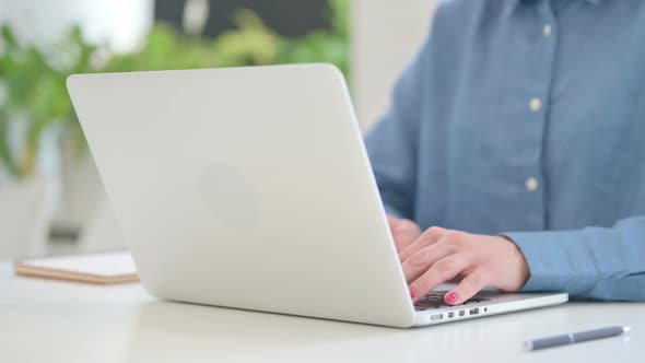 Woman Typing on Laptop