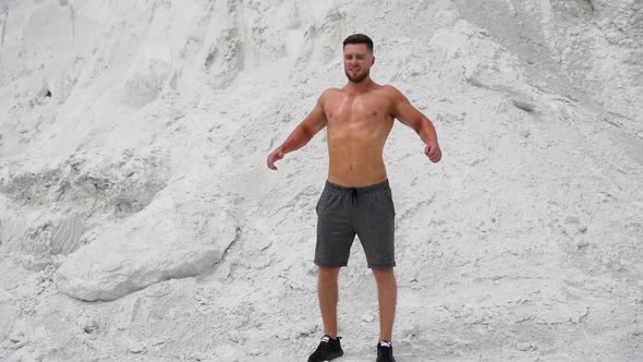 Bearded man with muscular body poses