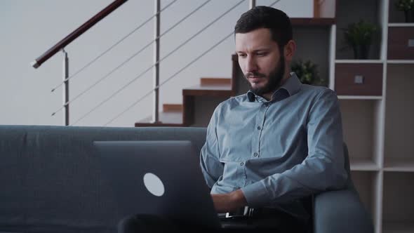 Man Using Laptop Computer and Working Distant Sitting at Home
