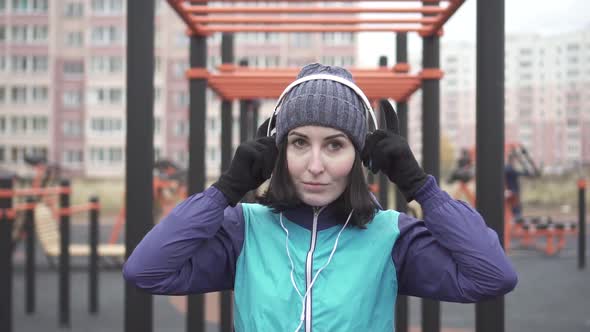 Portrait Woman Athlete with Headphones on the Street Playgroundslow Mo