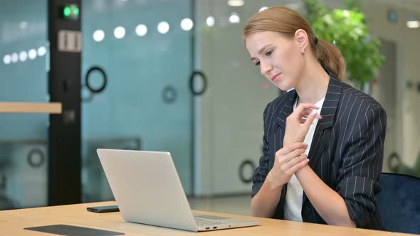 Businesswoman with Laptop Having Wrist Pain 