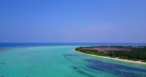 Wide angle drone tourism shot of a paradise sunny white sand beach and aqua blue ocean background