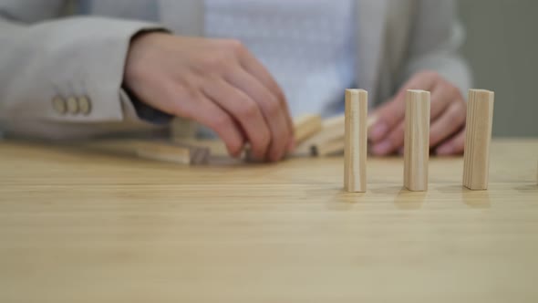 Business Woman Places Blocks in a Row After Falling