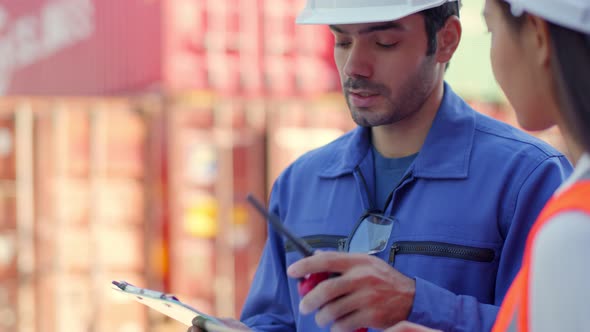 Two engineer male and female worker dockers in checking examine discussion