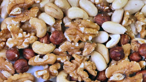 Rotating close up shot of many different nuts sorts,walnut,hazelnut,cashews.