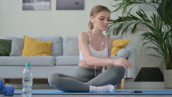 Young Woman Listening Music on Headphones and Meditating