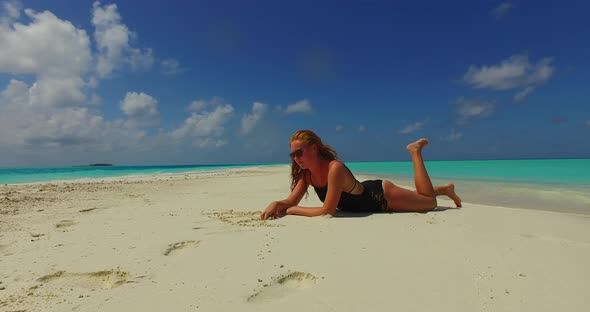 Modern smiling girls on holiday enjoying life at the beach on summer white sand and blue background 