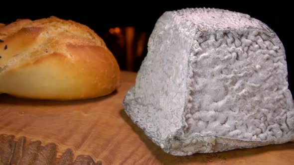 Pyramid Valencay Cheese Lying on a Wooden Board