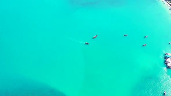 Aerial top down landscape of exotic bay beach trip by blue green sea with white sandy background of 