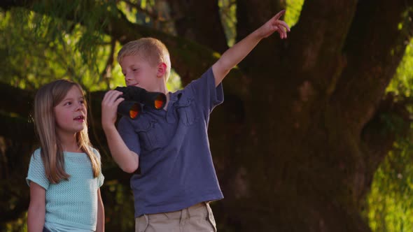 Two kids looking through binoculars