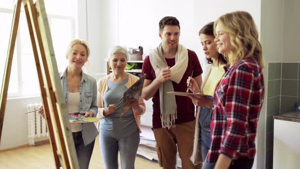 Group of Artists Discussing Painting at Art School