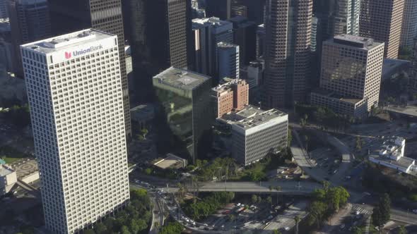 AERIAL: Birds Eye View of Downtown Los Angeles, California Intersection Traffic with Palm Trees and