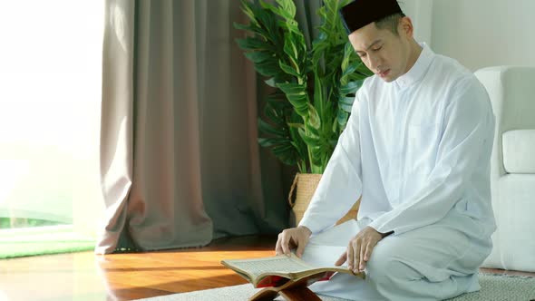 Asian Muslim Man Reading the Qur'an