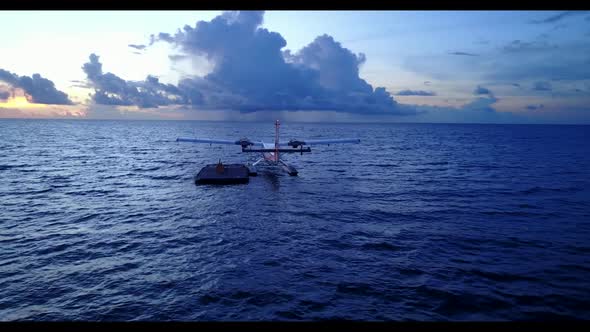 Aerial top view panorama of tranquil sea view beach vacation by turquoise water and bright sandy bac