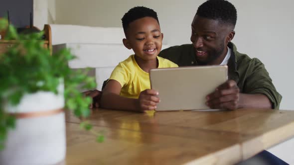 African american father and son using a digital tablet together