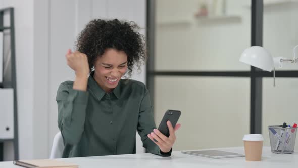 African Woman Celebrating Success Smartphone