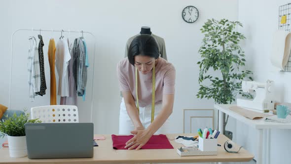 Slow Motion of Asian Woman Seamstress Working with Cloth and Chalk Creating New Modern Garment