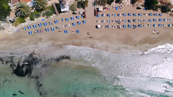 Top View of Sandy Beach on Shores of Crystal Clear Sea Equipped with Sun Loungers, Coral Bay, Cyprus