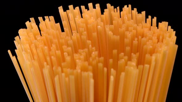 Spaghetti rotating on black background 