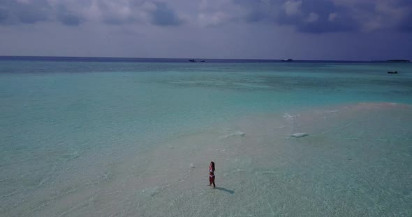 Pretty beauty model travelling having fun at the beach on summer white sand and blue background 4K